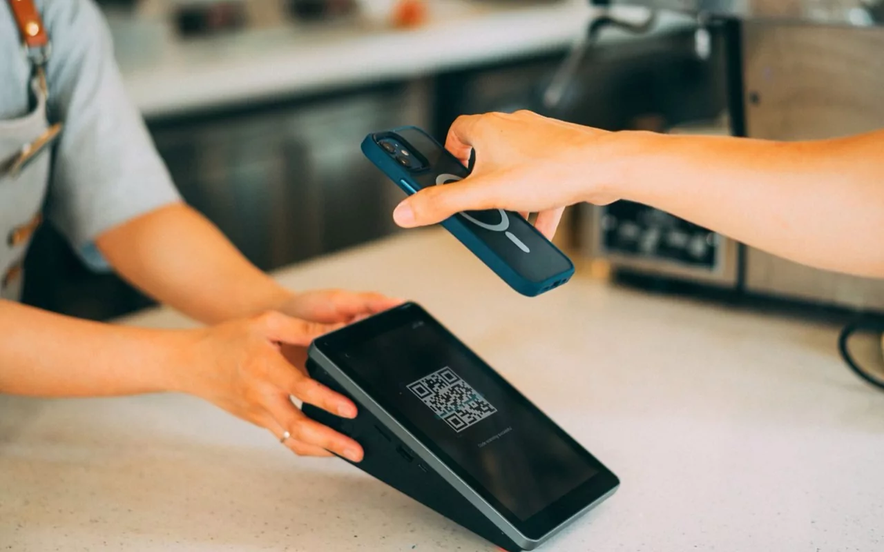 Resident tapping a phone at a contactless access reader